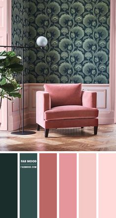 a living room with pink and green wallpaper, a red chair and a plant in the corner