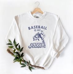 This Baseball Crewneck is perfect for the holidays! This cozy crewneck makes the perfect gift for that special sports lover in your life ;) . Snag it up for a festive holiday look. Disclaimer - Colors in listings may slightly vary depending on what device you are using - Prints may appear smaller depending on the shirt size ordered **MOCKUP IMAGE IS WHITE A unisex heavy blend crewneck sweatshirt that is soft, comfy, and cozy. The collar is ribbed knit, so it retains its shape even after washing. Baseball Season Fan Apparel Sweatshirt With Letter Print, Cotton Baseball Season Sports Sweatshirt, Cotton Sweatshirt For Baseball Season Sports, Sporty Crew Neck Sweatshirt For Baseball Season, Cotton Sweats For Sports, Baseball Season Sweatshirt With Lettering For Sports Events, Baseball Season Sports Fan Crew Neck Sweatshirt, Collegiate Sports T-shirt For Winter, Sports Fan Crew Neck Sweatshirt For Baseball Season