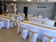 tables and chairs are set up with gold sashes on them for a banquet or party