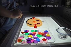 a child is playing at home mom's art project with colored paper and scissors