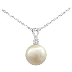 A beautiful pearl necklace, showcasing a 12 mm south sea pearl of golden color. Accented by a single round cut diamond weighing 0.16 carat. Suspended on an adjustable white gold chain, 18 inches in length.   Roman Malakov is a custom house, specializing in creating anything you can imagine. If you would like to receive a special quote on a custom piece, please message or call us. Round Diamond Pendant, Beautiful Pearl Necklace, Round Pendant Necklace, White Gold Chains, Sea Pearl, South Sea Pearls, Sea Pearls, Pearl Pendant Necklace, Color Dorado