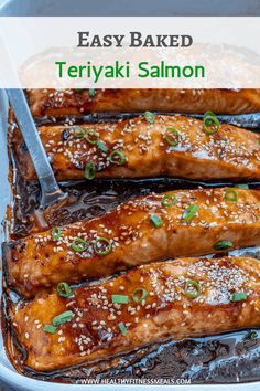 baked teriyaki salmon in a baking dish with sesame seeds