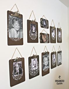 a group of pictures hanging on a wall with clothes pins attached to them and photos hung up against the wall