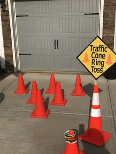 traffic cone ring tossers in front of a garage with a sign that says traffic cone ring toss