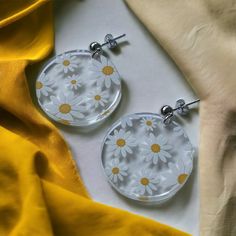 Add a touch of delicate beauty to your style with our laser cut acrylic daisy circle earrings. These exquisite earrings feature a 1.25-inch circle shape meticulously laser cut from clear acrylic, adorned with a charming white daisy pattern.

Crafted with attention to detail, these earrings come with s925 sterling silver findings, providing both durability and a hypoallergenic option for sensitive ears. Choose between the timeless elegance of gold or the sleek allure of silver to match your perso Laser Cut Earrings Acrylics, Laser Cut Earrings, White Daisy, Laser Cut Acrylic, Daisy Pattern, Circle Shape, Acrylic Earrings, Circle Earrings, Sensitive Ears