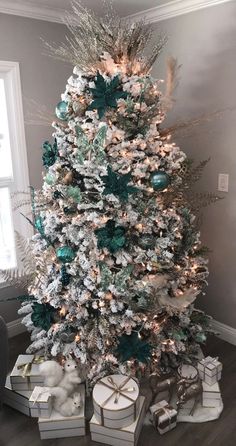 a white christmas tree with green and silver ornaments