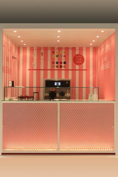 the inside of a pink and white striped restaurant