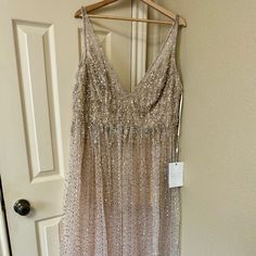 a dress hanging on a hanger in front of a door