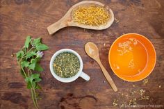 three bowls and spoons filled with different types of herbs