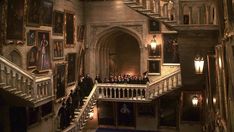 the staircase leading up to an old building with many people standing on it and looking down