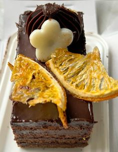 a piece of chocolate cake with orange slices on it