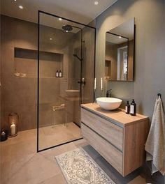 a bathroom with a sink, mirror and shower stall