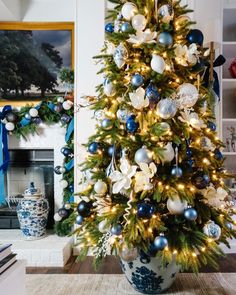 a decorated christmas tree with blue and white ornaments