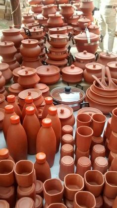 many clay pots are arranged on the table