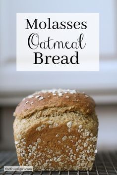 a loaf of molassses oatmeal bread on a cooling rack