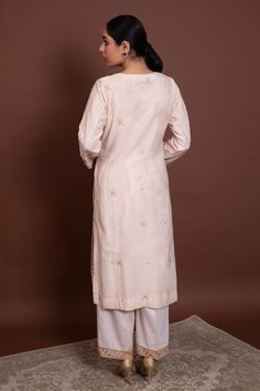 Light beige kurta with all-over chikankari embroidery and v-neck. Paired with straight pants and dupatta.
Component: 3
Embroidered
Neckline: V-Neck
Sleeve Length: Full
Fabric: Cotton Silk Mulmul
Color: White
Chikankari and jaal embroidery
Embroidered border on pants - Aza Fashions V-neck Cotton Kurta With Resham Embroidery, Festive V-neck Palazzo Set With Chikankari Embroidery, V-neck Chikankari Embroidery Kurta For Wedding, Cotton V-neck Kurta With Chikankari Embroidery, V-neck Chikankari Embroidery Sets For Diwali, Diwali V-neck Sets With Chikankari Embroidery, Diwali V-neck Chikankari Embroidery Sets, Semi-stitched V-neck Kurta With Dabka Work, Traditional V-neck Kurta With Chikankari Embroidery