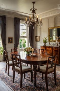 a dining room table with chairs and a chandelier