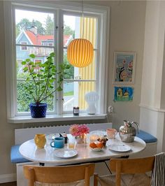 a dining room table with plates and cups on it