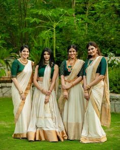 the bridesmaids are posing for a photo in their traditional sari attires