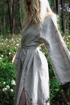 Organic and sustainable long beige linen kimono with long sleeves, splits and belt. Nightrobe made of locally produced linen in the North. Long Sleeve Linen Beach Robe, Summer Linen Robe With Long Sleeves, Summer Linen Long Sleeve Kimono, Long Sleeve Linen Kimono For Summer, Summer Long Sleeve Linen Kimono, Spring Long Sleeve Robe With Natural Dye, Neutral Long Sleeve Linen Dress, Beige Linen Kimono For Loungewear, Bohemian Linen Kimono For Loungewear