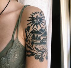 a woman's arm with a tattoo on it and a bra in the background