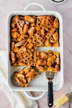 chicken and waffles casserole in a baking dish with a spatula