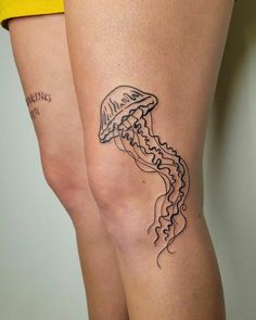 a woman's thigh with a tattoo of a jellyfish