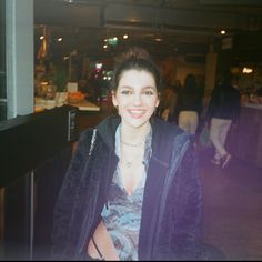 a woman standing in front of a counter at a restaurant