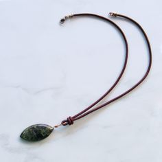 Unisex Leather Necklace 19.5" total length Dragon Blood Jasper, also known as Dragon Stone. We do our best to choose each stone carefully and purposefully for every piece.. However there might be slight differences in color size shape and clarity which makes each item unique and one of a kind. Each piece of jewelry will come in a colored drawstring bag or box for it’s protection and storage or to be ready to give as a gift.Our gemstone jewelry are all original designs by Lisa Beth and LDE Affini Leather Jewelry With Natural Stones For Gift, Dragon Stone, Dragon Blood, Dragons Blood, Jasper Gemstone, Leather Necklace, Drawstring Bag, Gemstone Jewelry, Original Designs