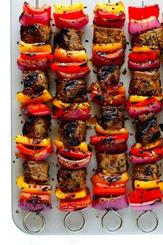 the skewers are covered with meat and vegetables