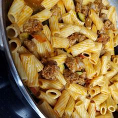 a pan filled with pasta and meat on top of a stove