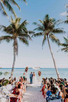 a wedding ceremony on the beach with palm trees