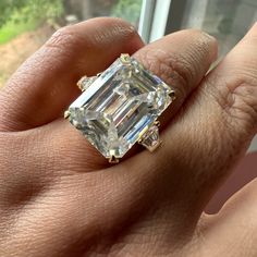 I Purchased This Gorgeous Ring From A Seller In India Ages Ago, But Somehow It Just Hasn’t Felt Like Mineis It Yours? With An Emerald-Cut Center Stone Measuring Approx. 13.5 X 18mm, This Ring Has A Dew (Diamond Equivalent Weight) Of About 20 Carats. Moissanite, However, Is Less Dense Than Diamond, So The Actual Weight Is Less. The Center Stone Is Flanked In Classic Three-Stone Style By Two Trapezoidal Moissanites Each Approx. 5 X (5, 3) Mm. If You’re Not Familiar With Moissanite, Do Your Homework Before Purchasing This Ring. Moissanite Passes Cheap Diamond Testers But Is Given Away By Its Outrageous Double-Rainbow Sparkle Endowed By Double Refraction And High Dispersion. At Mohs 9 Custom Emerald Cut Engagement Ring, Do Your Homework, Rainbow Sparkle, Double Rainbow, Emerald Cut Moissanite, Emerald Cut Rings, Gorgeous Ring, Emerald Engagement Ring Cut, Ring Moissanite