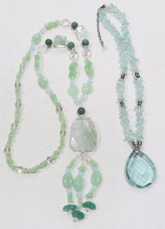 This is a set of two stunning quartz necklaces. 1. The first one is a really long green quartz with rock crystal, green quartz chips with tassels at the end. Unmarked. Necklace is 29 inches long. The dangle part is 5.8 inches long. The quartz part is 1.65' x1.25'. The piece weighs 96 grams. 2. The second necklace is faceted quartz crystal or glass. Has aquamarine colored chips with sparkling rhinestone spacers in between. It is 18 inches long, and the extender is 2.8 inches long. The main crysta Artisan Green Crystal Necklaces With Gemstone Beads, Handmade Green Crystal Long Necklace, Long Green Beaded Crystal Necklace, Green Faceted Bead Dangle Necklace, Long Bead Necklace, Blue Multi-strand Beaded Crystal Necklace, Crystal Green, Aquamarine Colour, Color Chip