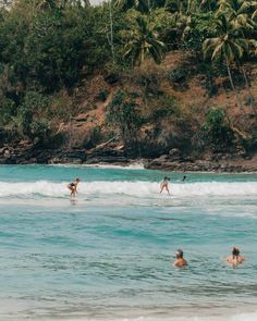 some people are playing in the water on surfboards