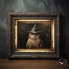 an owl wearing a witches hat and holding a broom in front of a framed photograph