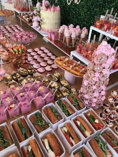 a table filled with lots of food and desserts