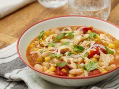 a bowl of chicken and bean soup with cilantro