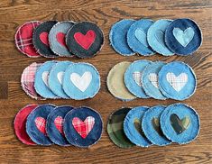 several pieces of cloth with hearts on them sitting on a wooden table next to each other