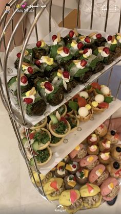 three tiered trays filled with different types of food