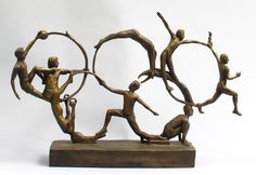 a bronze sculpture depicting three men doing different things with their hands in the air and holding onto each other's arms