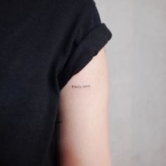 a woman with a small tattoo on her arm that says, there's love