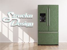 a green refrigerator freezer sitting on top of a hard wood floor next to a white wall