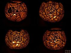 four carved pumpkins with candles in the center and spider web designs on each one