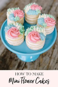 a blue plate topped with cupcakes covered in frosting and pink icing