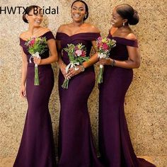 three women in long purple dresses standing next to each other and smiling at the camera