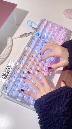 a woman is typing on a keyboard with her hands and nails in the keyshell