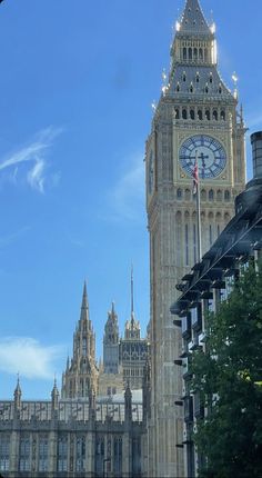 the big ben clock tower towering over the city of london, england on a sunny day