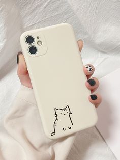 a woman's hand holding a phone case with a cat drawn on it