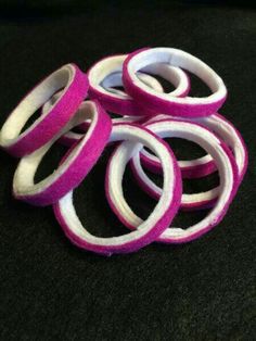 pink and white rubber bands stacked on top of each other in the shape of rings